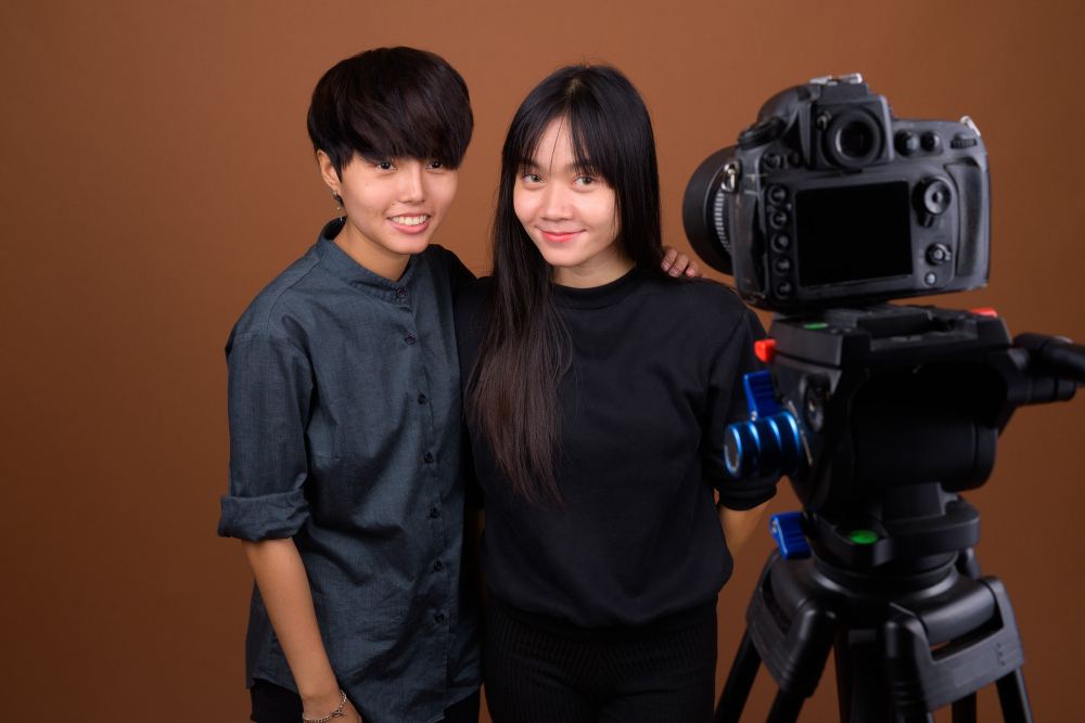 Two young teenagers making a video.